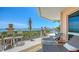 Spacious covered balcony with outdoor seating and stunning views of the ocean and horizon at 420 Golden Gate Pt # 200A, Sarasota, FL 34236
