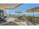 Expansive balcony featuring dining and seating areas and breathtaking water views at 420 Golden Gate Pt # 200A, Sarasota, FL 34236