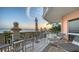 Exterior view of a spacious balcony with lounge chairs and stunning sunset water views at 420 Golden Gate Pt # 200A, Sarasota, FL 34236