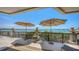 Wide-open outdoor deck with seating and views of the bay, protected by two large sun umbrellas at 420 Golden Gate Pt # 200A, Sarasota, FL 34236