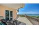 Covered outdoor patio seating area with furniture and a scenic view of the bay and boats at 420 Golden Gate Pt # 200A, Sarasota, FL 34236