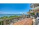 Large balcony with dining and lounge seating featuring panoramic waterfront views at 420 Golden Gate Pt # 200A, Sarasota, FL 34236