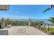 Spacious tiled balcony overlooking the bay with a compass rose design in the tile and elegant railing at 420 Golden Gate Pt # 200A, Sarasota, FL 34236