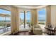 Relaxing sitting area leading to a balcony with panoramic ocean views at 420 Golden Gate Pt # 200A, Sarasota, FL 34236