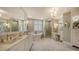 Luxurious bathroom featuring double vanities, soaking tub, and glass-enclosed shower at 420 Golden Gate Pt # 200A, Sarasota, FL 34236