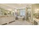 Elegant bathroom featuring a soaking tub, double vanities, and a walk-in shower at 420 Golden Gate Pt # 200A, Sarasota, FL 34236