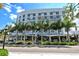 Contemporary building exterior with evenly spaced palm trees lining the front, adding a touch of elegance to the street at 420 Golden Gate Pt # 200A, Sarasota, FL 34236