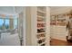 Custom walk-in closet with built-in shoe racks and shelving for organized storage at 420 Golden Gate Pt # 200A, Sarasota, FL 34236