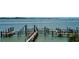 A wooden dock extends into the water offering boat access and waterfront views at 420 Golden Gate Pt # 200A, Sarasota, FL 34236