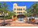 Impressive building with arched balconies, adorned with trees in large terracotta pots at 420 Golden Gate Pt # 200A, Sarasota, FL 34236