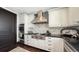 Well-appointed kitchen with stainless steel appliances, white cabinetry, and a quartz backsplash for cooking enthusiasts at 420 Golden Gate Pt # 200A, Sarasota, FL 34236