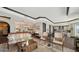 Spacious condo living and dining area boasts hardwood floors, elegant furnishings, and water views at 420 Golden Gate Pt # 200A, Sarasota, FL 34236