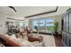 Bright condo living space with water views, comfortable seating, and access to a private balcony at 420 Golden Gate Pt # 200A, Sarasota, FL 34236