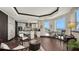 Bright living room featuring a kitchen, water view, and stylish furniture; ideal for relaxation and entertaining at 420 Golden Gate Pt # 200A, Sarasota, FL 34236