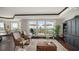 Elegant condo living room features water views, hardwood floors, and comfortable seating at 420 Golden Gate Pt # 200A, Sarasota, FL 34236