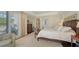 Relaxing main bedroom featuring balcony access and an adjoining walk-in closet at 420 Golden Gate Pt # 200A, Sarasota, FL 34236