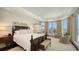 Spacious main bedroom with large windows offering stunning water views and lots of light at 420 Golden Gate Pt # 200A, Sarasota, FL 34236