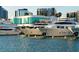 Modern yachts docked at a waterfront marina, with sleek designs and a backdrop of contemporary buildings at 420 Golden Gate Pt # 200A, Sarasota, FL 34236