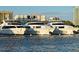Luxurious yachts docked in a marina, showcasing sleek designs and modern amenities on Sarasota Bay at 420 Golden Gate Pt # 200A, Sarasota, FL 34236
