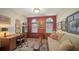 Comfortable office features multiple windows, a sofa, a desk, and ample artwork for a warm and inviting space at 420 Golden Gate Pt # 200A, Sarasota, FL 34236