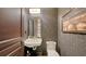 Stylish powder room featuring unique wallpaper, a vessel sink, and modern fixtures at 420 Golden Gate Pt # 200A, Sarasota, FL 34236