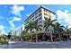 Charming street view with palm trees, a commercial building, and outdoor dining creating a vibrant atmosphere at 420 Golden Gate Pt # 200A, Sarasota, FL 34236