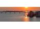 Sunset view features waterfront building, the bridge and the tranquil bay at 420 Golden Gate Pt # 200A, Sarasota, FL 34236