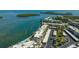 Stunning aerial view of waterfront condo complex with boat docks and beautiful surrounding nature at 4420 Exeter Dr # L104, Longboat Key, FL 34228