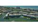 Stunning aerial view of waterfront condos with boat docks, pools, and lush landscaping near the beach at 4420 Exeter Dr # L104, Longboat Key, FL 34228