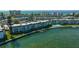 Aerial shot showing waterfront condo with a private dock and boat, near a refreshing community pool at 4420 Exeter Dr # L104, Longboat Key, FL 34228
