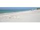 Sandy beach with beachgoers and clear water, perfect for a relaxing vacation at 4420 Exeter Dr # L104, Longboat Key, FL 34228