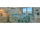 Comfortable bedroom with waterfront view, a queen bed, and matching nightstands with seashell lamps at 4420 Exeter Dr # L104, Longboat Key, FL 34228