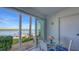 Bright dining area featuring sliding glass doors with serene water views and a table with seating for four at 4420 Exeter Dr # L104, Longboat Key, FL 34228
