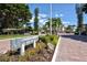 The Longboat Harbour entrance sign surrounded by colorful landscaping under a bright blue sky at 4420 Exeter Dr # L104, Longboat Key, FL 34228
