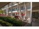 Exterior view of condo building with vibrant tropical landscaping at 4420 Exeter Dr # L104, Longboat Key, FL 34228