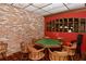 Unique game room features a poker table, brick accent wall, and comfortable seating at 4420 Exeter Dr # L104, Longboat Key, FL 34228