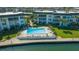 Aerial shot of the complex's pool area with deck chairs and beautifully maintained landscaping at 4420 Exeter Dr # L104, Longboat Key, FL 34228