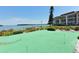 Lush community putting green overlooking the bay for golf practice with a scenic view at 4420 Exeter Dr # L104, Longboat Key, FL 34228