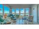 Enclosed lanai boasts stunning water views and inviting sitting area at 4420 Exeter Dr # L104, Longboat Key, FL 34228