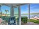 Enjoy stunning waterfront views from the cozy sunroom with floor to ceiling windows and sliding glass door at 4420 Exeter Dr # L104, Longboat Key, FL 34228