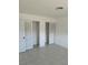 Inviting bedroom featuring neutral walls, tile floors and double closets with sliding doors at 4444 Swift Rd # 14, Sarasota, FL 34231