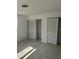 Cozy bedroom with tiled floors and closet with sliding doors, providing ample storage at 4444 Swift Rd # 14, Sarasota, FL 34231