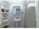Bathroom featuring a shower, a pedestal sink, a vanity, and a display shelf at 4621 Gulf Of Mexico Dr # 2F, Longboat Key, FL 34228