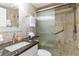 Updated bathroom with granite countertop, tiled shower with glass door, and modern fixtures at 4621 Gulf Of Mexico Dr # 2F, Longboat Key, FL 34228