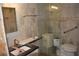 Renovating bathroom showing marble vanity, tiled walls, and a toilet installation in progress at 4621 Gulf Of Mexico Dr # 2F, Longboat Key, FL 34228