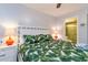 Well-lit bedroom with two twin beds, coastal-themed bedding, and ensuite bathroom access at 4621 Gulf Of Mexico Dr # 2F, Longboat Key, FL 34228