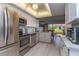 Modern kitchen features stainless steel appliances, white cabinets, and an open view to the outside patio at 4621 Gulf Of Mexico Dr # 2F, Longboat Key, FL 34228