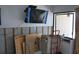 Living room under construction showing bare walls, covered television, and items for project completion at 4621 Gulf Of Mexico Dr # 2F, Longboat Key, FL 34228