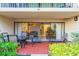 Cozy outdoor patio with dining area offers seamless indoor-outdoor living at 4621 Gulf Of Mexico Dr # 2F, Longboat Key, FL 34228