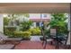 Charming outdoor patio with a table, chairs and lush landscaping for relaxed outdoor living at 4621 Gulf Of Mexico Dr # 2F, Longboat Key, FL 34228